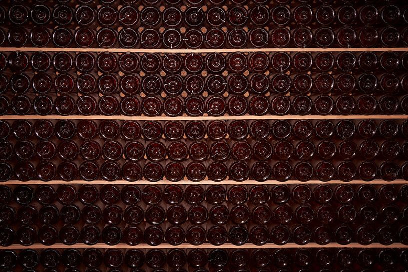Wine bottles on shelves in the wine cellar by Gevk - izuriphoto