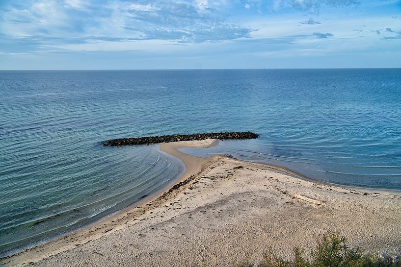 Stone groyne juts into the sea on a sandy beach in Denmark by Martin Köbsch