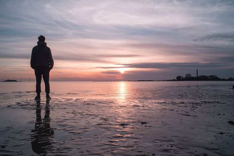 Beautiful sunset with reflection on the sand by Jolien Kramer