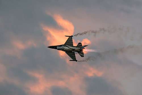 F-16 with afterburner at sunset