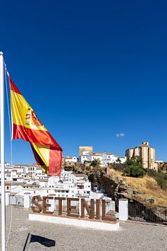 Panorama or skyline of a historic old town with many white houses. The Spanish flag in Setenil de las Bodegas, Cádiz, Andalusia, Spain by Fotos by Jan Wehnert