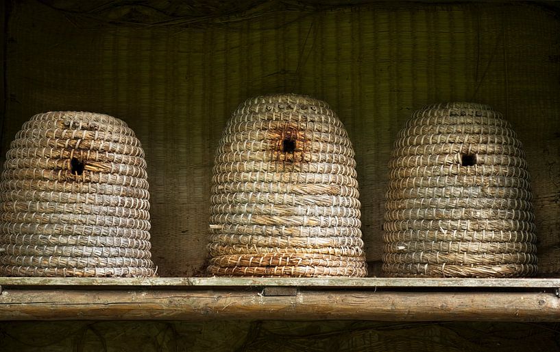 Old straw beehives in rural ambience by Birgitte Bergman