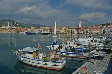 A port full of boats and yachts with town Imperia at the background. by Gert van Santen