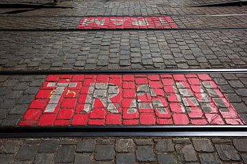 Antwerp Urban streetcar text on cobblestones by Blond Beeld