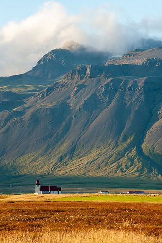Lonely church in front of a vast mountain landscape