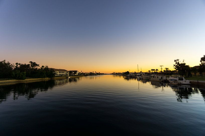 USA, Florida, Sunset behind water of large river with boats and houses by adventure-photos