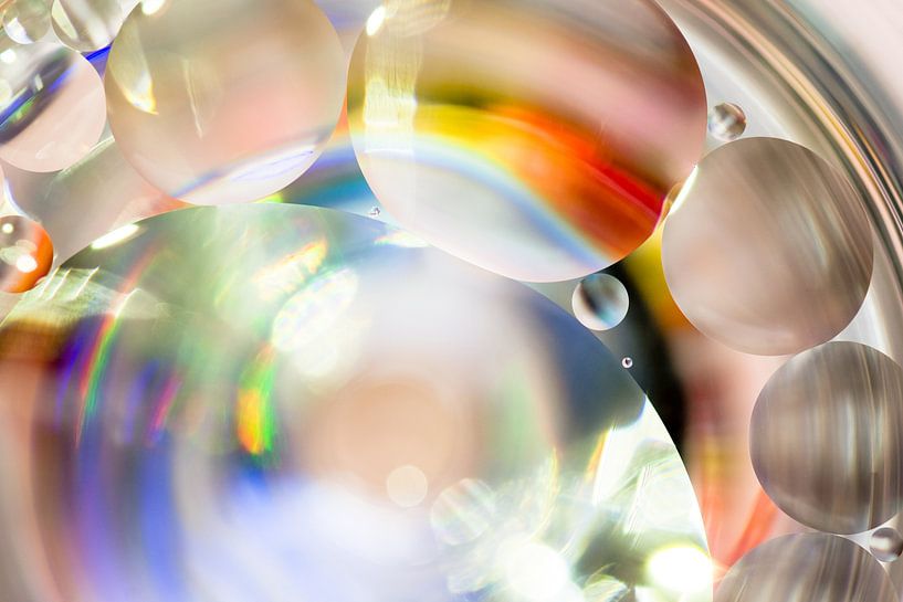 Colorful oil droplets in the water by Jolanda Aalbers