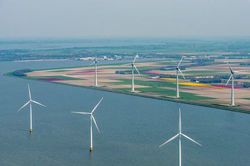 Aerial view of wind turbines on the coast in front of various colors o by Sjoerd van der Wal