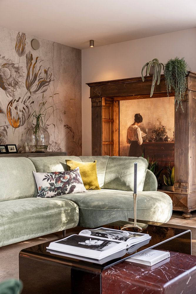 Interior with the artist's wife standing at a chest of drawers reading, Carl Holsøe 