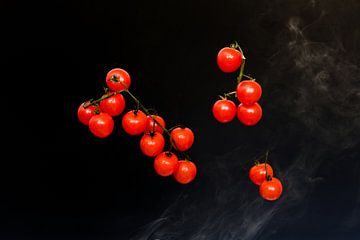 Red cherry tomatoes against a black background by Wim Stolwerk