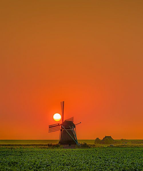 Windmill behind the Wadden dike near Marrum in Friesland by Harrie Muis