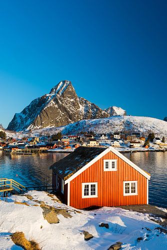 Typische rote Fischerhütte, Rorbu, bei Reine auf den Lofoten Inseln im Winter mit Schnee