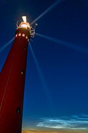 Schiermonnikoog lighthouse with shining night clouds by Karin de Jonge