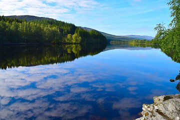 Reflection of clouds in a crystal clear Scottish lake by Studio LE-gals