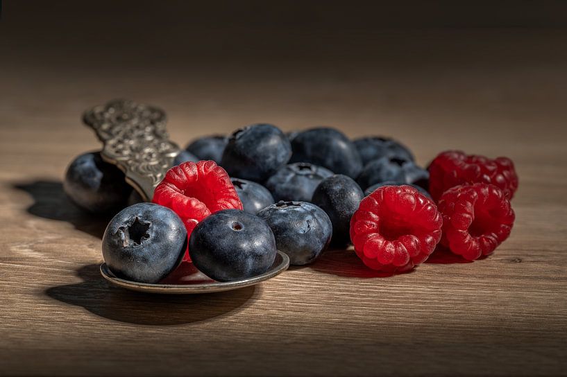 Modern stilleven met blauwe bessen en frambozen par John van de Gazelle fotografie