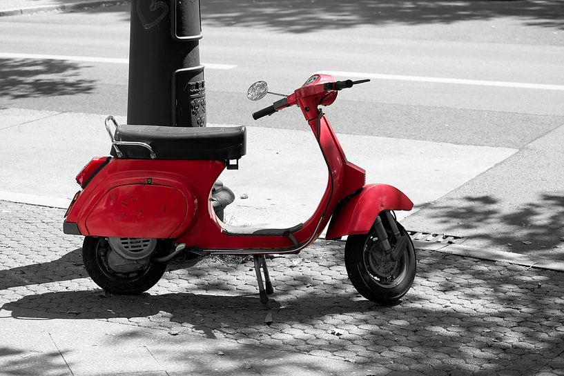 red motor scooter at the roadside by Heiko Kueverling