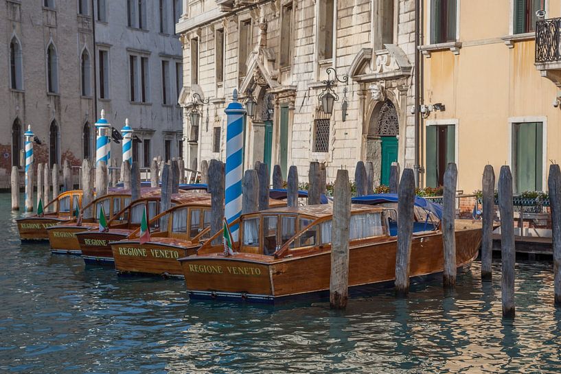 Old buildings and wooden speedboats on a canal in the old town of Venice, Italy by Joost Adriaanse