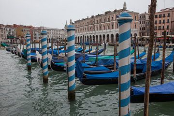 Gondolas with blue sails in the main canal in Venice, Italy. by Joost Adriaanse