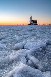 Lighthouse in frozen lake by Tim Vlielander