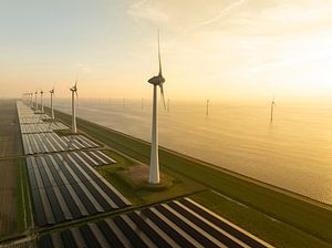 Wind turbines and solar panels on a lakeshore