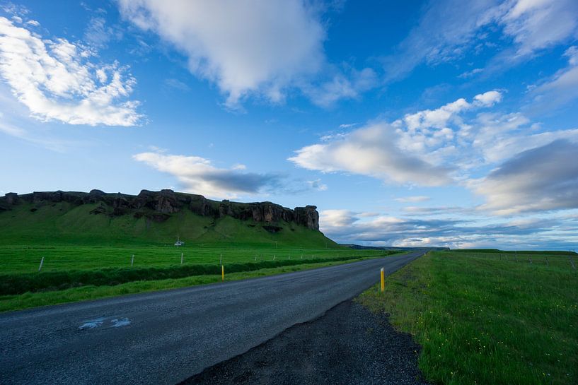Iceland - Blue sky over street between green meadow and volcanic landscape by adventure-photos