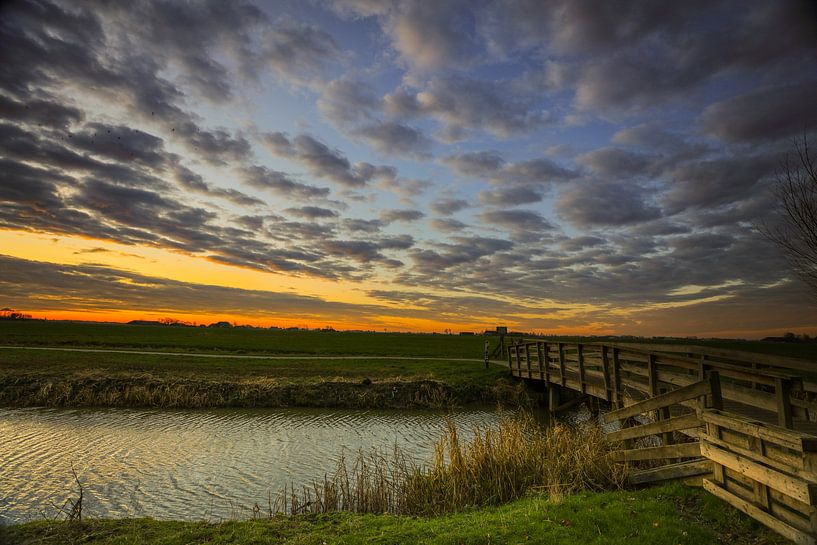 Bridge across the canal, with sunrise. by Henk Cruiming