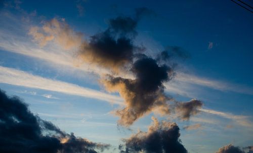Blue sky with dark clouds.
