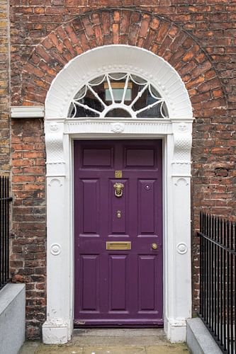 The purple door of house number 27