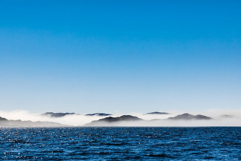 Sea mist between the rocky coast near Aasiaat, Greenland by Martijn Smeets