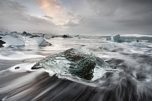 Block of ice on the black beach