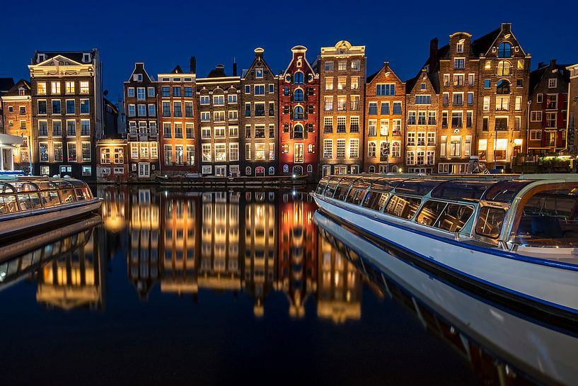 Amsterdam houses on the Damrak at night by Eye on You