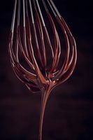 SF12468512 Liquid chocolate dripping from a whisk