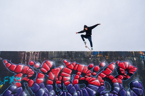 Skateboarder op graffiti muur