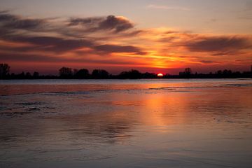 Sunset over natural ice in the floodplain by Willemijn Wolthaus