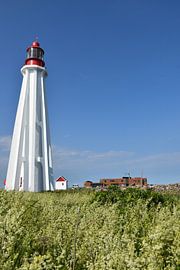 The lighthouse under a blue sky by Claude Laprise
