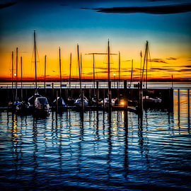 Sailing boats in the harbour at sunset