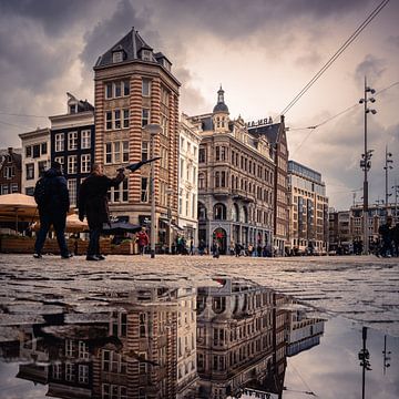 Street life in Amsterdam on the dam during after a winter shower