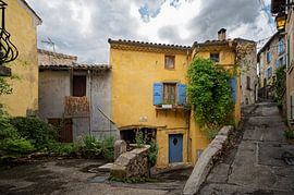 Yellow house with blue shutters in Crest France by Peter Bartelings