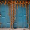 Blue door with flowers in Nepal by Ellis Peeters