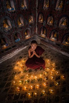 Praying monk in monastery near Inle Lake in Nyaung Shwe Myanmar inn. Boys and girls should all at a  by Wout Kok
