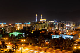 Illuminated mosque above the evening traffic in Muscat by Jeroen Kleiberg