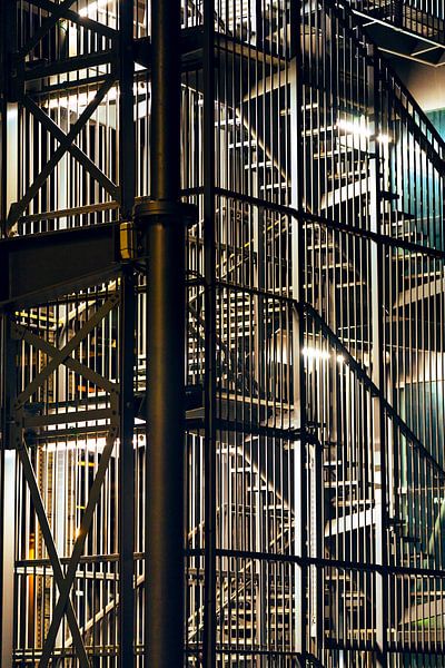 Industrial staircase under artificial light . by Rik Verslype