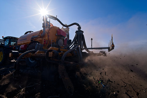 Tractor with a slurry tank in a field
