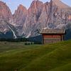 An almhut in front of the Sassolungo and Sasso Piatto peaks by Luc van der Krabben