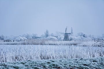 Frisian Mill in winter landscape with skaters. by Scarlett Bus