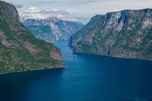 Aurlandsfjord in Norway with steep green mountains and blue water