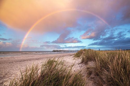 Baltic Sea beach of Heiligenhafen with pier and rainbow