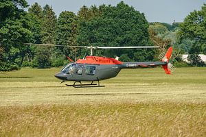 Low-flying Bell 206B JetRanger. by Jaap van den Berg