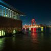 Rotterdam's red Willemsbrug in the evening with reflections by Bart Ros
