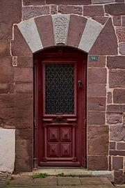 Beautiful ironwork in lilla red door Saint Jean Pied de Port by Ton Van Zeijl